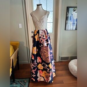 Soieblu maxi gown with a white lace floral bodice with a navy blue floral skirt.